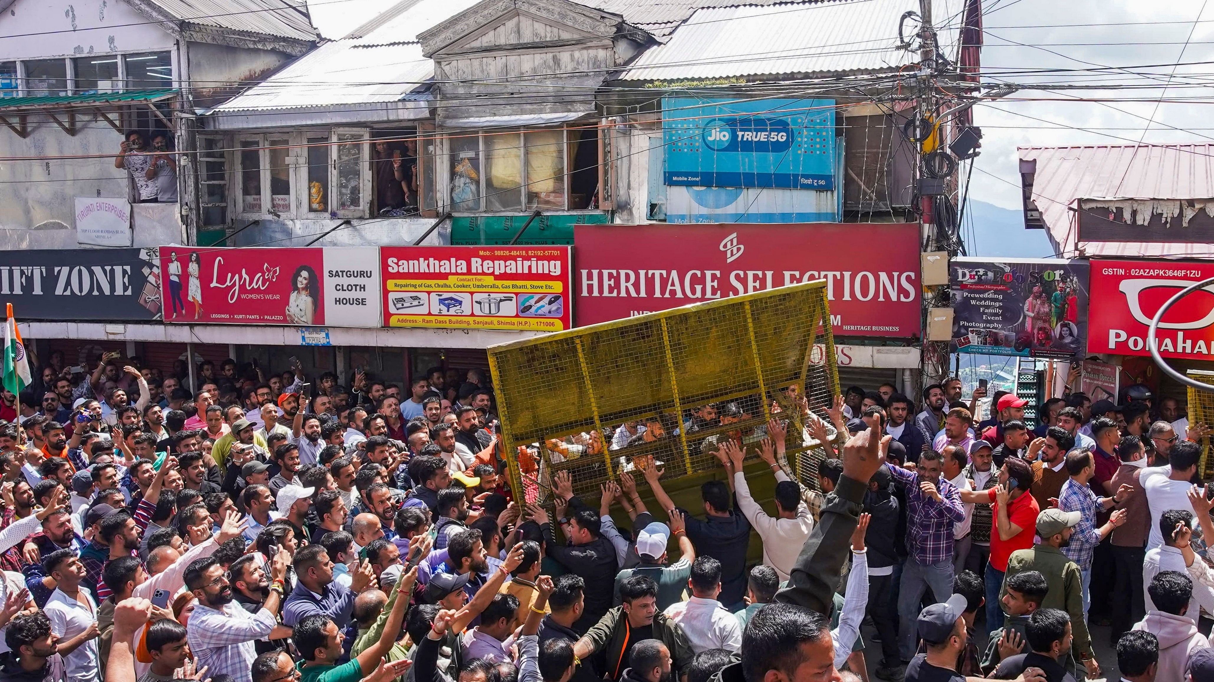 <div class="paragraphs"><p>Protestors try to break security cover during a protest over illegal construction in a mosque, at Sanjauli locality in Shimla.</p></div>